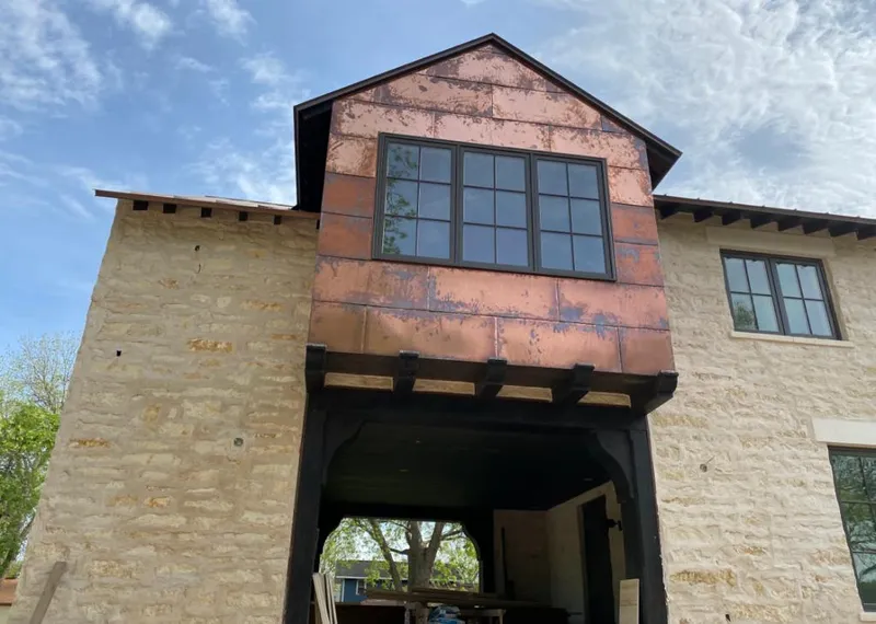 Copper metal panel facade on a stone building for Metal Roof Coating in Snyderville