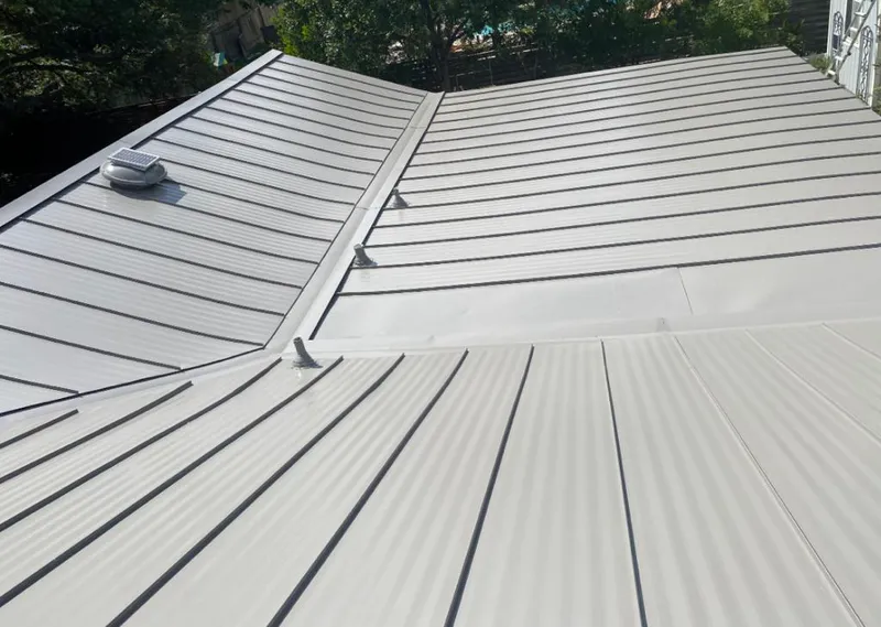 Solar attic fan installed on a metal roof for Roof Ventilation in Snyderville